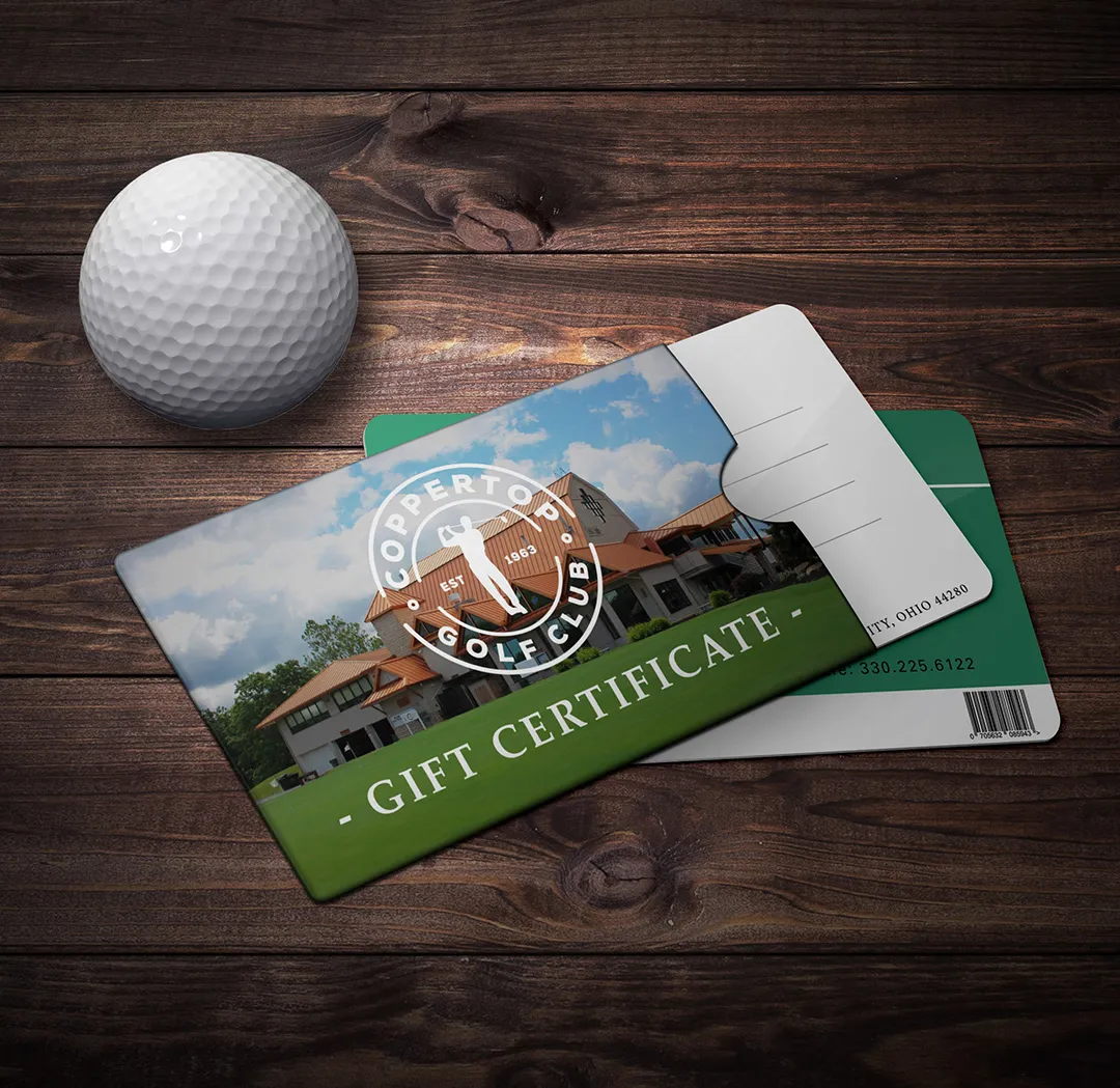 Coppertop gift certificates on a wooden table with a golf ball