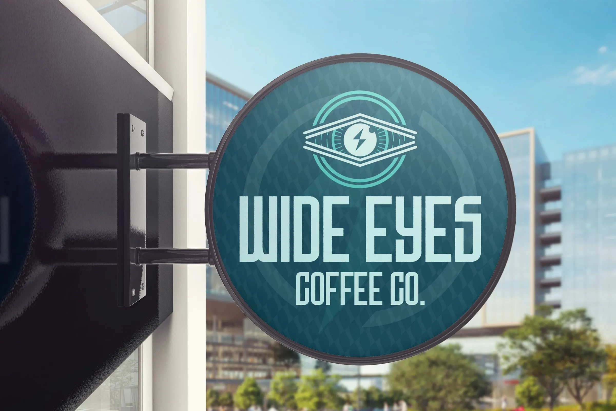 Round Wide Eyes sign hanging over a city sidewalk